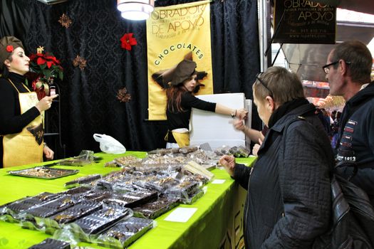 Jijona, Alicante, Spain- December 9, 2018: People walking and buying traditional nougat at the Jijona Christmas Fair