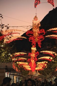 Xixona, Alicante, Spain- December 9, 2018: Christmas lighting at the fair of Turron in Jijona, Alicante province, Spain. Crowded streets