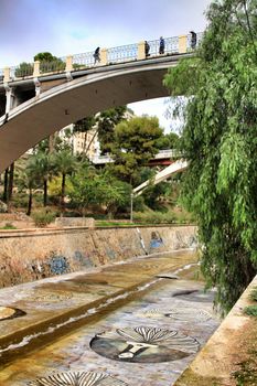 Elche, Alicante, Spain- November 16, 2018 - Landscape of the hillside of the Vinalopo River in Elche with its bridges and green vegetation after a rainy day of Autumn