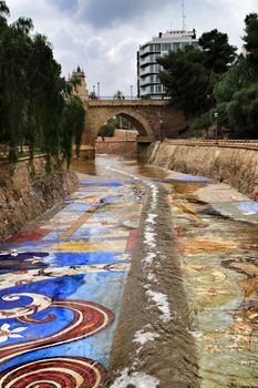 Elche, Alicante, Spain- November 16, 2018 - Landscape of the hillside of the Vinalopo River in Elche with its bridges and green vegetation after a rainy day of Autumn