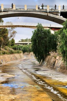 Elche, Alicante, Spain- November 16, 2018 - Landscape of the hillside of the Vinalopo River in Elche with its bridges and green vegetation after a rainy day of Autumn