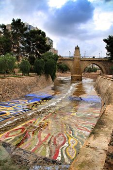 Elche, Alicante, Spain- November 16, 2018 - Landscape of the hillside of the Vinalopo River in Elche with its bridges and green vegetation after a rainy day of Autumn