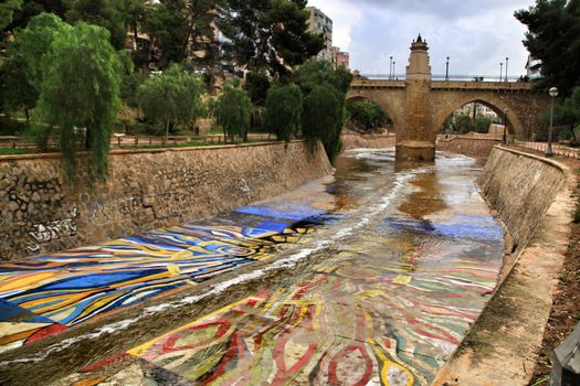Elche, Alicante, Spain- November 16, 2018 - Landscape of the hillside of the Vinalopo River in Elche with its bridges and green vegetation after a rainy day of Autumn