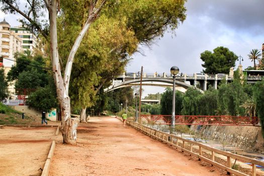 Elche, Alicante, Spain- November 16, 2018 - Landscape of the hillside of the Vinalopo River in Elche with its bridges and green vegetation after a rainy day of Autumn
