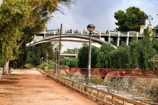 Elche, Alicante, Spain- November 16, 2018 - Landscape of the hillside of the Vinalopo River in Elche with its bridges and green vegetation after a rainy day of Autumn