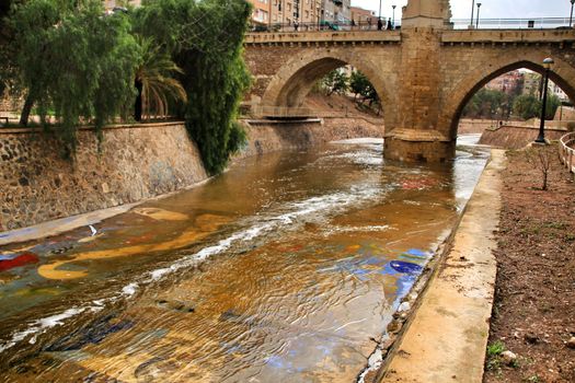 Elche, Alicante, Spain- November 16, 2018 - Landscape of the hillside of the Vinalopo River in Elche with its bridges and green vegetation after a rainy day of Autumn