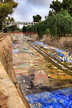 Elche, Alicante, Spain- November 16, 2018 - Landscape of the hillside of the Vinalopo River in Elche with its bridges and green vegetation after a rainy day of Autumn