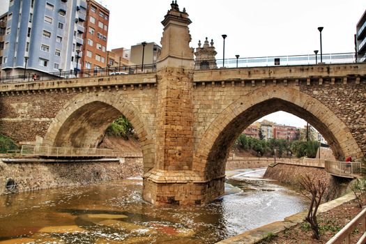 Elche, Alicante, Spain- November 16, 2018 - Landscape of the hillside of the Vinalopo River in Elche with its bridges and green vegetation after a rainy day of Autumn