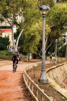 Elche, Alicante, Spain- November 16, 2018.- Young people doing sport next to the river in the park in Elche in Autumn