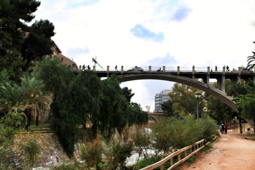 Elche, Alicante, Spain- November 16, 2018 - Landscape of the hillside of the Vinalopo River in Elche with its bridges and green vegetation after a rainy day of Autumn
