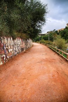Elche, Alicante, Spain- November 16, 2018 - Landscape of the hillside of the Vinalopo River in Elche with its bridges and green vegetation after a rainy day of Autumn
