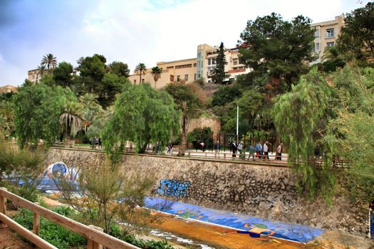Elche, Alicante, Spain- November 16, 2018 - Landscape of the hillside of the Vinalopo River in Elche with its bridges and green vegetation after a rainy day of Autumn