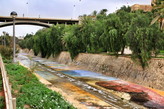 Elche, Alicante, Spain- November 16, 2018 - Landscape of the hillside of the Vinalopo River in Elche with its bridges and green vegetation after a rainy day of Autumn