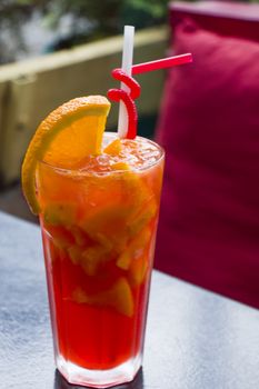 Alcoholic cocktail and lemonade with citruses, orange color cocktail on the table