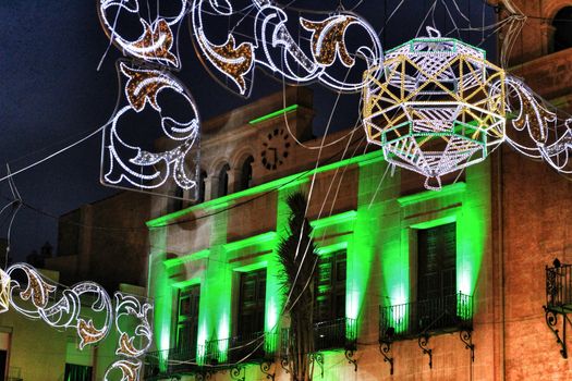 Elche, Spain- August 13, 2018: Elche town hall square decorated with colorful bulbs and garlands for the festivities