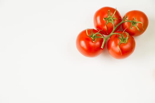 Red four tomatoes on the white background, vegetable