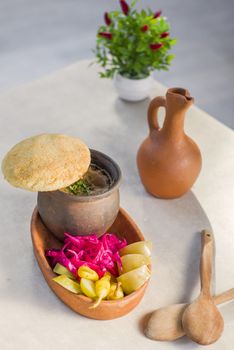 Georgian traditional food Lobio or kidney and haricot beans soup with picked vegetables and red wine. Tbilisi, Georgia.