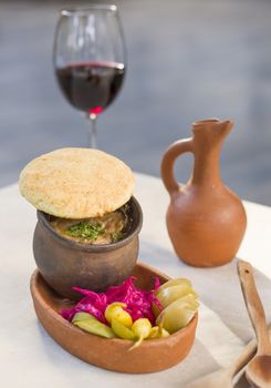 Georgian traditional food Lobio or kidney and haricot beans soup with picked vegetables and red wine. Tbilisi, Georgia.