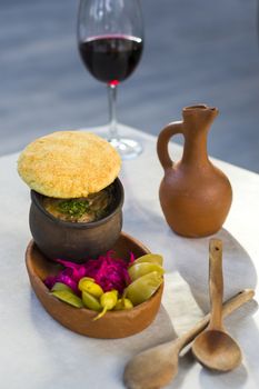 Georgian traditional food Lobio or kidney and haricot beans soup with picked vegetables and red wine. Tbilisi, Georgia.