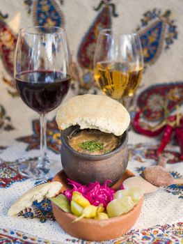 Georgian traditional food Lobio or kidney and haricot beans soup with picked vegetables and red wine. Tbilisi, Georgia.