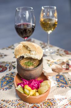 Georgian traditional food Lobio or kidney and haricot beans soup with picked vegetables and red wine. Tbilisi, Georgia.