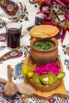 Georgian traditional food Lobio or kidney and haricot beans soup with picked vegetables and red wine. Tbilisi, Georgia.