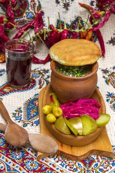 Georgian traditional food Lobio or kidney and haricot beans soup with picked vegetables and red wine. Tbilisi, Georgia.