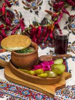 Georgian traditional food Lobio or kidney and haricot beans soup with picked vegetables and red wine. Tbilisi, Georgia.