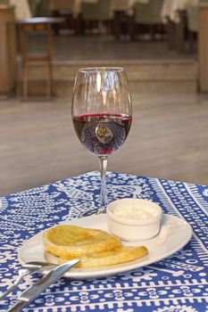 Potatoes dumpling with souse on the plate and red wine. ready to eat.