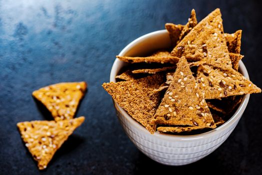 Sesame triangular crispy chips in bowl