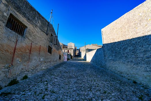 Italy, Sicily, Trapani Province, Erice. A narrow cobblestone street in the ancient hill town of Erice