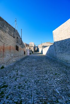 Italy, Sicily, Trapani Province, Erice. A narrow cobblestone street in the ancient hill town of Erice