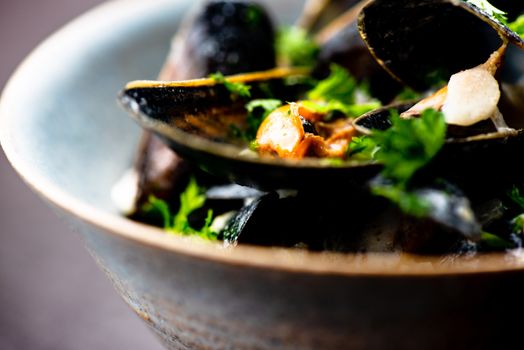 Cooked Blue mussels in clay dish close up