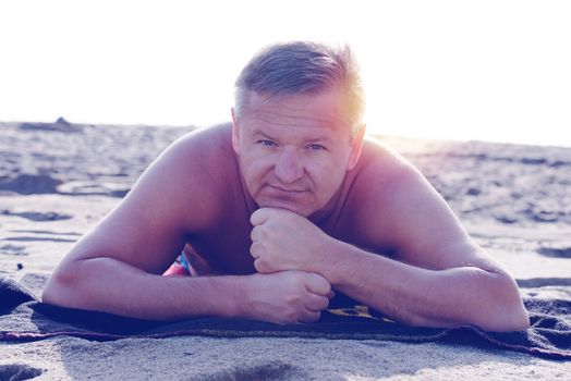 Man relaxing on sandy beach