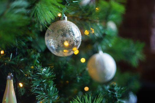 Beautiful Christmas tree decorated with colorful toys and garlands. New Year atmosphere.