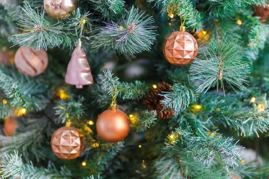 Beautiful Christmas tree decorated with colorful toys and garlands. New Year atmosphere.