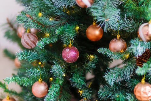 Beautiful Christmas tree decorated with colorful toys and garlands. New Year atmosphere.