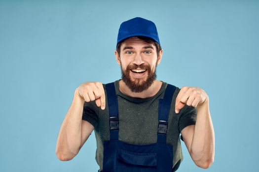 man in work uniform uniform professional work lifestyle delivery service blue background. High quality photo