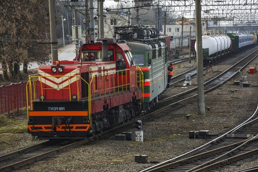 Shunting diesel locomotive pulls the train at the railway yard