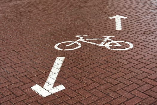 On the paving slab there is a road sign "Bike path"