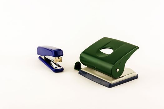 Stationery - stapler and punch on a light background