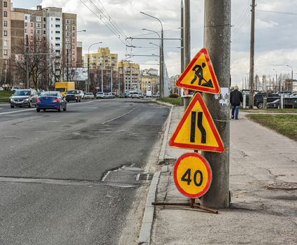 On the road there are signs warning about the repair of the road