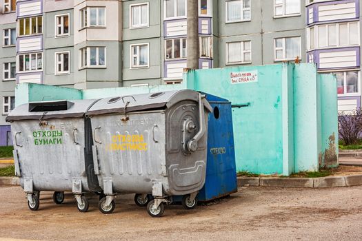 Metal garbage containers in the courtyard of a residential building