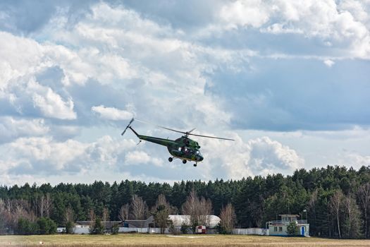 Helicopter MI-2 takes off from the ground airfield