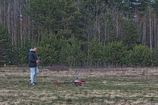 Modelist with a model of a radio-controlled helicopter