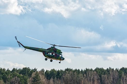 Belarus, Minsk - 15.04.2017: The helicopter MI-2 carries out a control flight around the forest belt