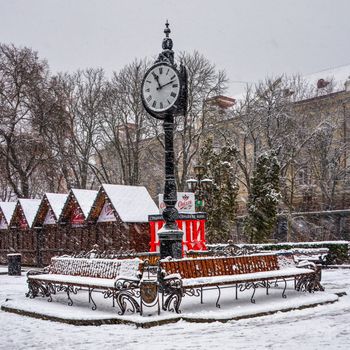 Ternopil, Ukraine 01.05.2020.  Tripartite clock in Ternopol, Ukraine, on a snowy winter morning