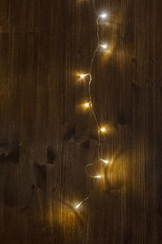 a row of small lights on a wooden background