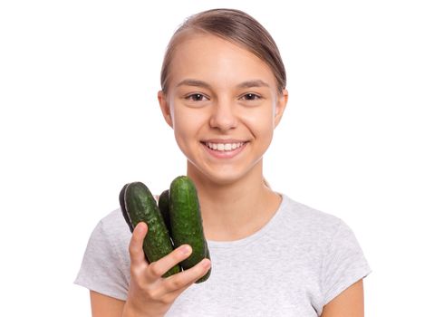 Beautiful young teen girl holding green cucumbers, isolated on white background