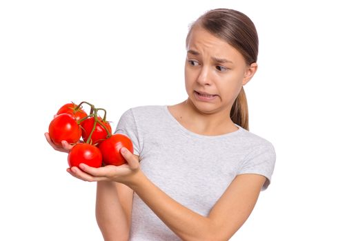 Beautiful young teen girl holding fresh tomatoes, isolated on white background